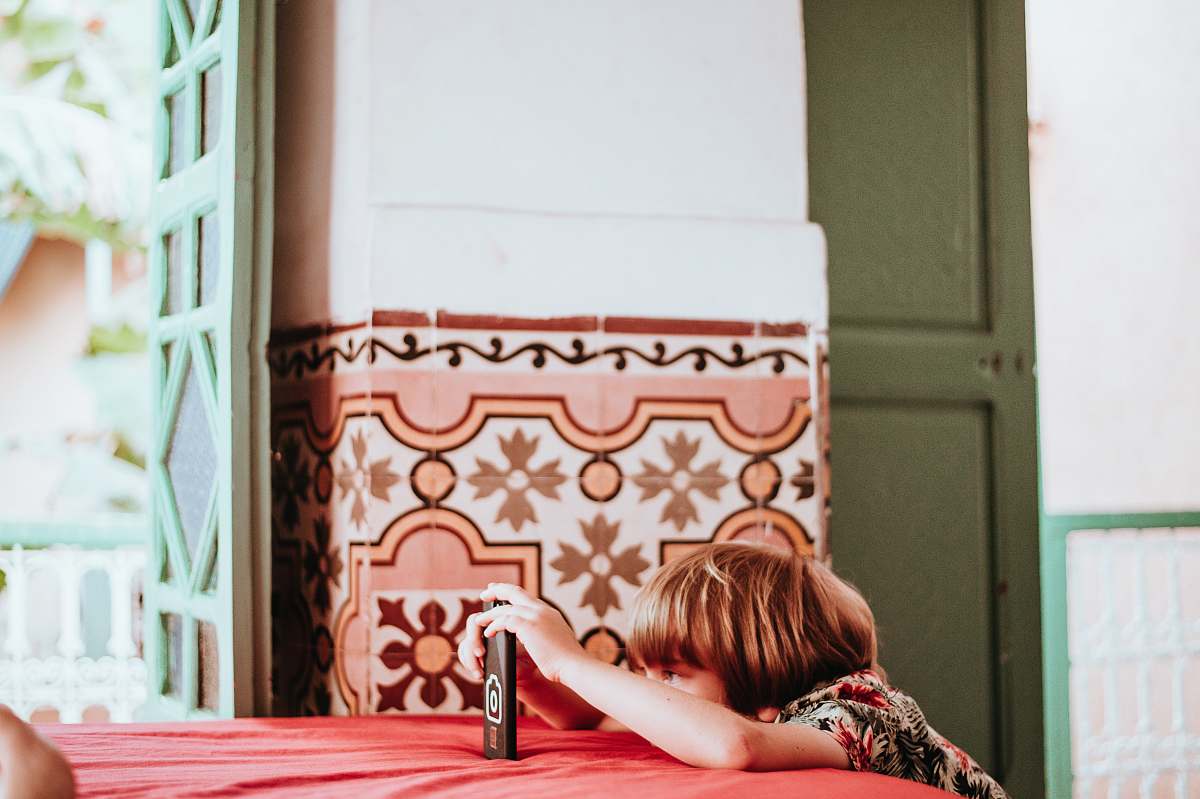 human toddler using smartphone indoors person